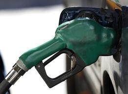 A gas nozzle is used to pump petrol at a station in New York February 22, 2011.