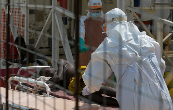 Health workers attend to an Ebola patient in Sierra Leone, Dec. 22, 2014. 