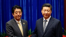 China's President Xi Jinping (R) shakes hands with Japan's Prime Minister Shinzo Abe at APEC meetings in Beijing, Nov. 10, 2014.