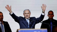 Israeli Prime Minister Benjamin Netanyahu waves to supporters at the party headquarters in Tel Aviv March 18, 2015. 