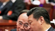 China's President Xi Jinping (R) speaks to Wang Qishan, a member of the Standing Committee of the Political Bureau of the Communist Party of China (CPC). Beijing, March 4, 2015.