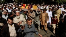 Men carry the coffin of Samiullah Afridi, who was killed by unidentified gunmen a day earlier, during his funeral in Peshawar March 18, 2015. 
