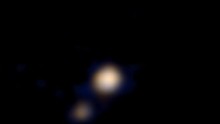 Pluto and its largest moon, Charon, from 115 million kilometers