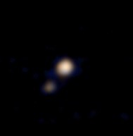 Pluto and its largest moon, Charon, from 115 million kilometers