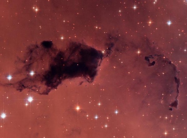 This Hubble image features dark knots of gas and dust known as "Bok globules," which are dense pockets in larger molecular clouds. Similar islands of material in the early universe could have held as much water vapor as we find in our galaxy today, despit