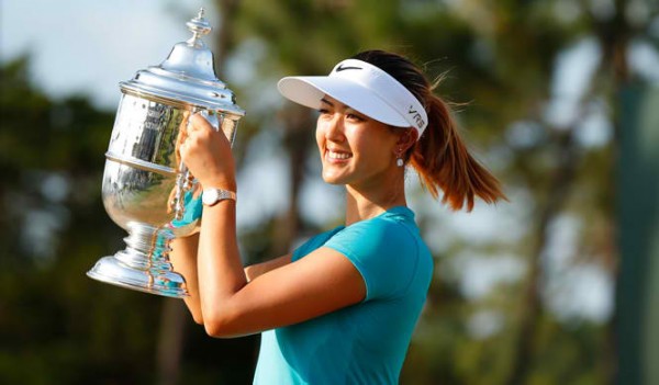 Michelle Wie collects her trophy after winning the 2014 U.S. Women's Open golf tournament