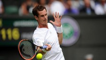 Defending champion Andy Murray slams a forehand against Belgian Goffin at Wimbledon