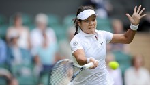 Second seed Li Na slams a hard forehand against Polish Kania at Wimbledon