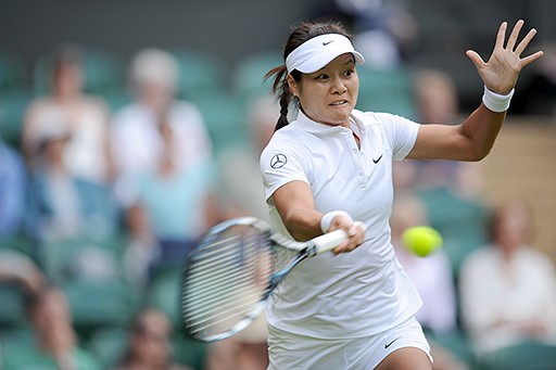 Second seed Li Na slams a hard forehand against Polish Kania at Wimbledon