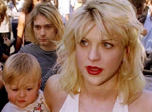 Kurt Cobain (L) with wife Courtney Love (holding their daughter Frances Bean Cobain) as they arrive at the MTV Music Awards in Los Angeles, California September 1992.