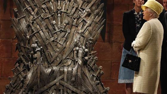 Queen Elizabeth II stops by to admire the Iron Thrones, the seat of power in medieval fantasy TV series "Game of Thrones."