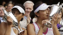 Peng Shuai and Hsieh Su-wei kissing their Wimbledon trophies