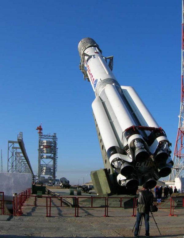 The Proton-M, part being rotated to vertical. In the background, the mobile service tower can also be observed.
