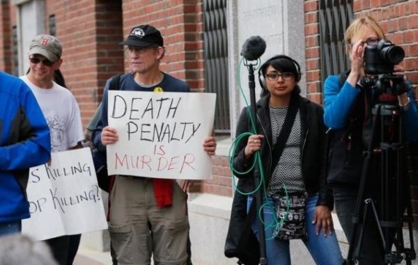 Death penalty protesters and media await the announcement of the sentencing verdict in the trial of Boston Marathon bomber Dzhokhar Tsarnaev outside the federal courthouse in Boston, Massachusetts May 15, 2015.