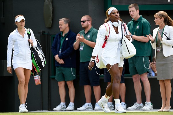Serena Williams and Alize Cornet walks to Court No. 1 at the All England Club