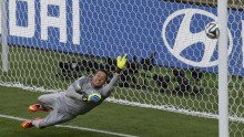 Brazil's goalkeeper Julio Cesar stretches as a shot by Chile's Gonzalo Jara hits the goalpost