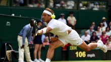 Rafael Nadal reaches for a backhand in an a match at the 2014 Wimbledon Championships
