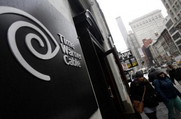 Pedestrians walk past a Time Warner Cable customer service center in New York February 13, 2014.