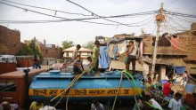 Local residents crowd to collect free drinking water supplied by a municipal corporation water tanker.