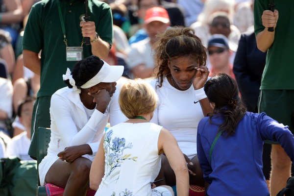 Serena Williams attended to by doctors during her warm-up at the 2014 Wimbledon Championships