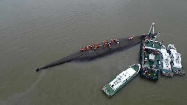 An aerial view shows rescue workers searching on the sunken ship 