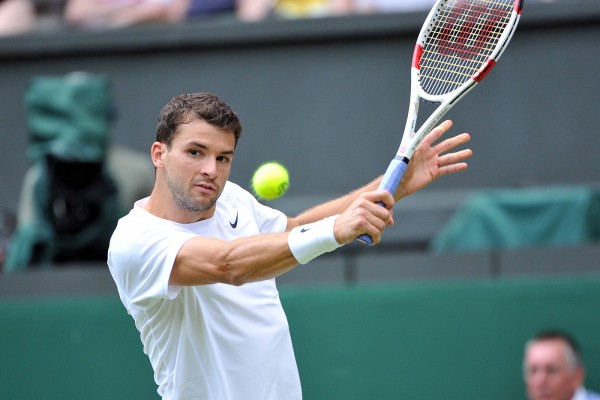 Grigor Dimitrov delivers a precise backhand drop shot against Andy Murray at the Wimbledon quarterfinals