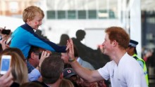 Britain's Prince Harry gives a high-five to a young fan 