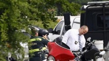 A police officer inspects a motorcycle 