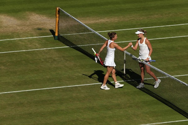 Eugenie Bouchard and Simona Halep shake hands after their semi-finals match at Wimbledon