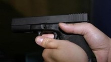 A unidentified man holds a Glock 9 mm pistol