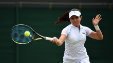 Jhie Zheng delivers a forehand smash in the ongoing Wimbledon Championships