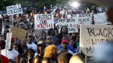 Protestors listen during a rally against what demonstrators call police brutality in McKinney, Texas June 8, 2015.