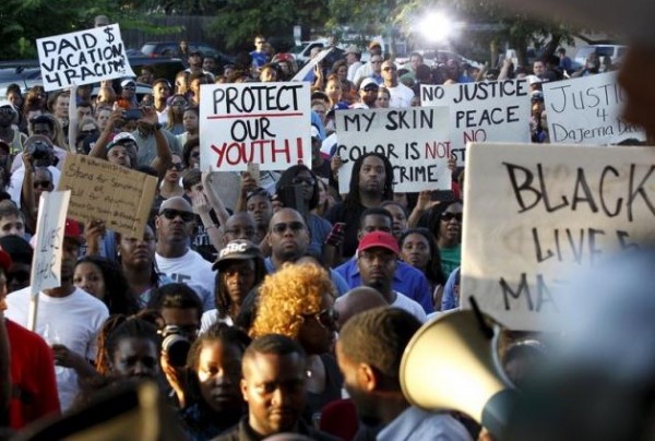 Protestors listen during a rally against what demonstrators call police brutality in McKinney, Texas June 8, 2015.