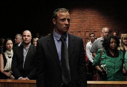 Oscar Pistorius awaits the start of court proceedings in the Pretoria Magistrates court February 19, 2013. 