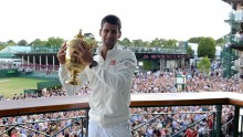 Serbian Novak Djokovic raising his 2014 Wimbledon Championship cup