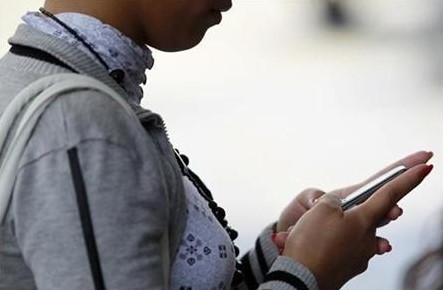 A woman uses her mobile phone in Caracas, March 29, 2010.