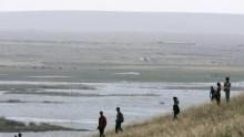 Mainland visitors tour a pasture beside a lake near Xilinhot in Inner Mongolia, China, September 23, 2007. The steppes of Inner Mongolia are arid even at the best of times, but low rainfall as world temperatures rise is turning these grasslands into sand.