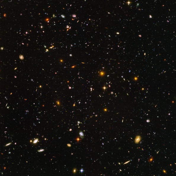 What Is Holding 800 Almost-Invisible Galaxies Together?