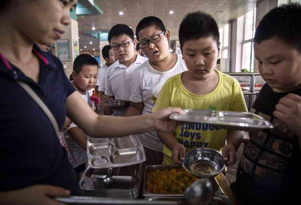 Chinese Boys Lining Up To Obtain Healthy Meals