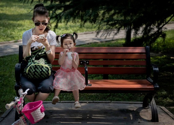 A Chinese woman and a girl enjoying their time at a park