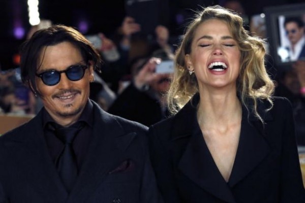 Actor Johnny Depp and girlfriend Amber Heard laugh as they arrive for the UK premiere of ''Mortdecai'' at Leicester Sqaure in London January 19, 2015.
