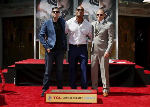 May 2015 file photo of Dwayne "The Rock" Johnson with Director Brad Peyton and producer Beau Flynn at TCL Chinese Theatre for his movie 'San Andreas.'