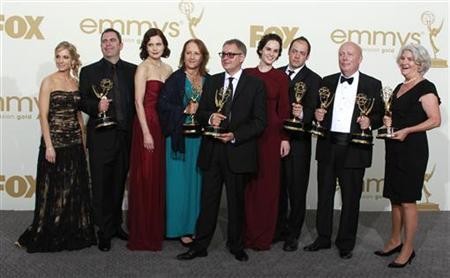 The cast and crew of ''Downton Abbey,'' winners for outstanding miniseries or movie, and outstanding writing for a miniseries, movie or a dramatic special, pose backstage at the 63rd Primetime Emmy Awards in Los Angeles September 18, 2011.