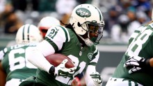 Chris Johnson carries the ball in a game against the New England Patriots as a member of the Jets. 