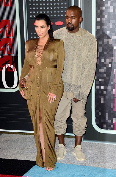 Kanye West (R) and tv personality Kim Kardashian
