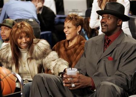 Singer Brandy (L) sits in audience with Miami Heat center Shaquille O'Neal (R) 