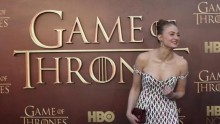 Actress Sophie Turner gestures while arriving for the season premiere of HBO's ''Game of Thrones''