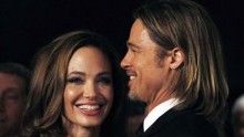 Actress Angelina Jolie smiles with her partner Brad Pitt 