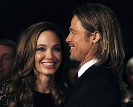 Actress Angelina Jolie smiles with her partner Brad Pitt 