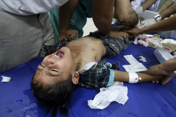 Palestinian medics tend to a boy who they said was wounded in an Israeli shelling
